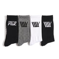 Four pairs of LUXBMX Crew Socks (4 Pack Mix)—in black, gray, white, and black—are displayed side by side, each showcasing striking graphic logos or text on the cuffs. Crafted for both comfort and durability, these crew socks are perfect for BMX riders who want a blend of style and performance.