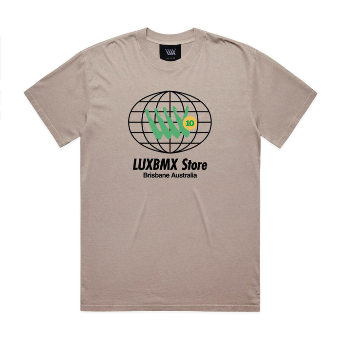 LUXBMX Eighty Eight Tee Faded Mushroom: A beige t-shirt featuring a black globe graphic, green hand symbol, "LUXBMX Store" text, and "Brisbane Australia" printed below the design—a subtle nod to Brisbane’s vibrant spirit and its iconic World Expo 88 heritage.
