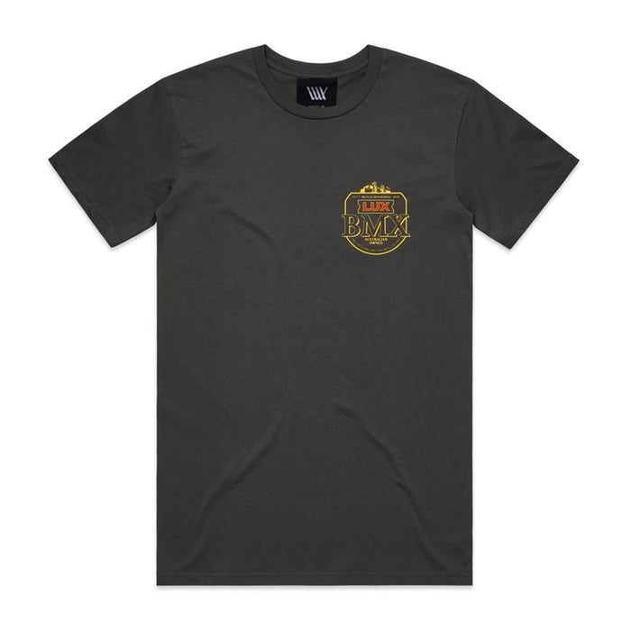 LUXBMX Gold Tee Coal – a black short-sleeve classic crewneck featuring a small yellow "LUX BMX" crest logo on the left chest, showcased on a flat white background. A must-have for any fan of this Brisbane icon.