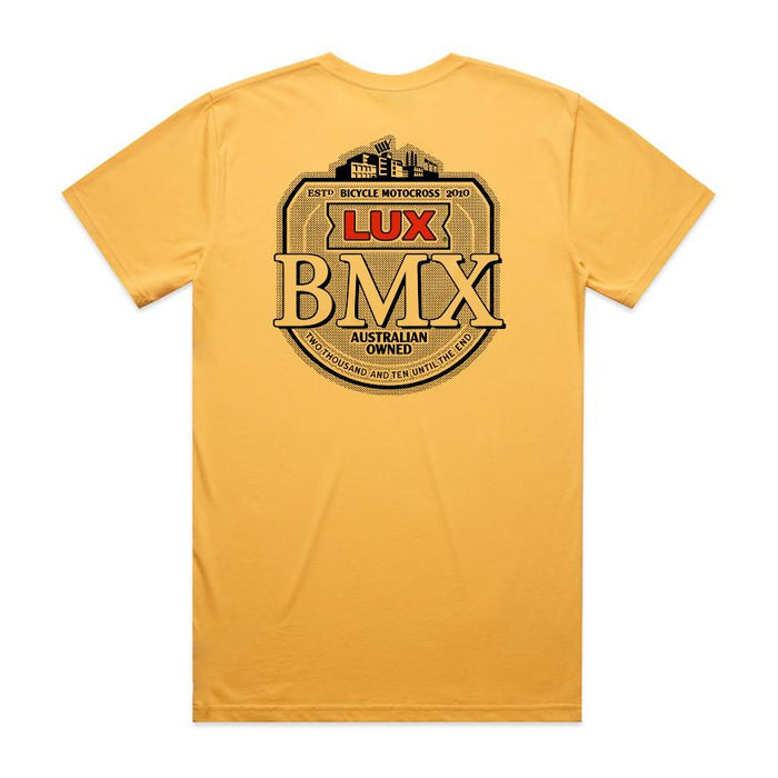 The LUXBMX Gold Tee Sunset is a classic yellow crew tee featuring a large circular LUX BMX badge and bold "Australian Owned" text printed in black and red on the back—truly a Brisbane icon.