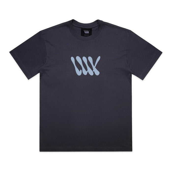 The LUXBMX Times Neue Tee Ink Blue is a black short-sleeve t-shirt crafted from heavyweight cotton, featuring a light blue abstract “WW” logo on the chest and shown laid flat on a white background—an ideal choice for fans of Bicycle Motocross style.