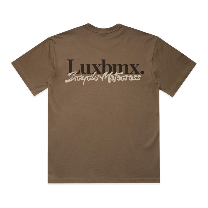 Introducing the LUXBMX Times Neue Tee Walnut—a brown short-sleeve heavyweight cotton t-shirt featuring "Luxbmx. Bicycle Motocross" printed in bold black and white text across the back, making it an essential choice for any BMX enthusiast.