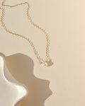 mother of pearl bead wrapped onto a dainty 14k solid gold necklace chain