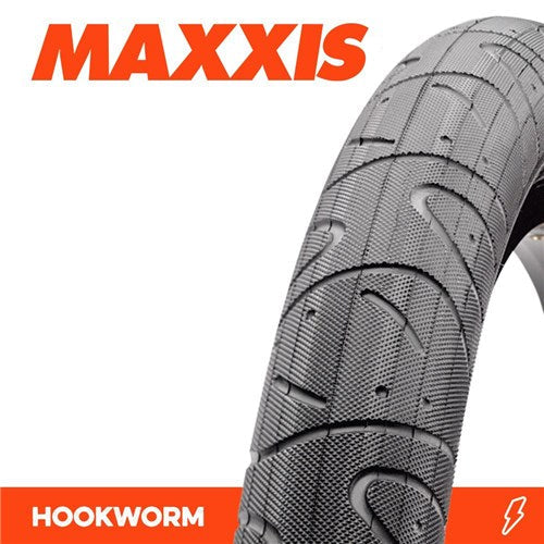 A close-up of the Maxxis Hookworm 24 Inch Tyre showcases its flat-resistant tread, with the Maxxis logo above and "HOOKWORM" in bold orange and white below.