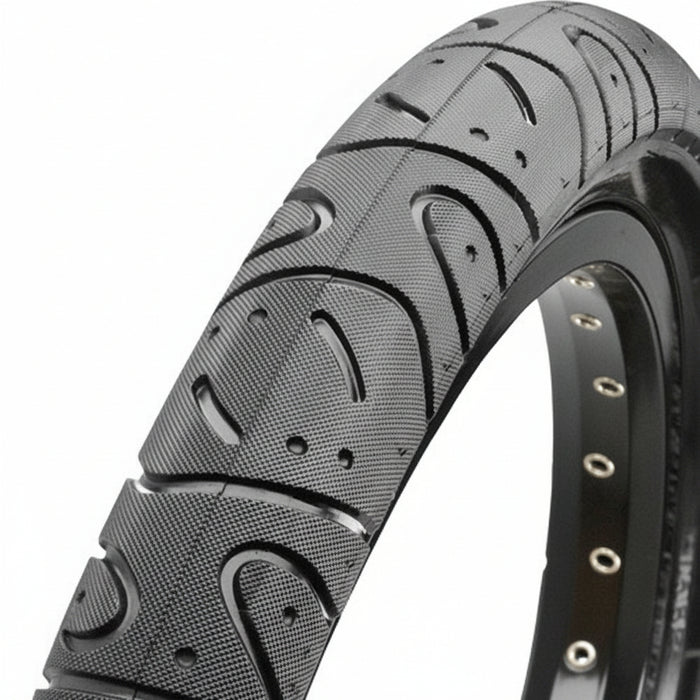 Close-up of a black Maxxis Hookworm 29 Inch Tyre showcasing its textured tread and rim eyelets, designed for urban riding.