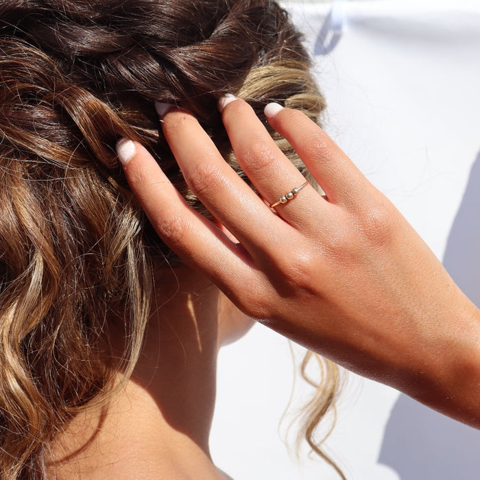 Model wearing 14k gold fill Meridian Fidget Ring