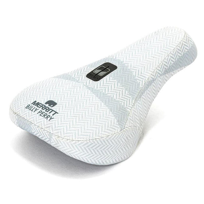 The Merritt Billy Perry Pivotal Seat features a white herringbone canvas cover, "MERRITT BILLY PERRY" text, and a logo patch—making it a stylish, durable upgrade for your bike.