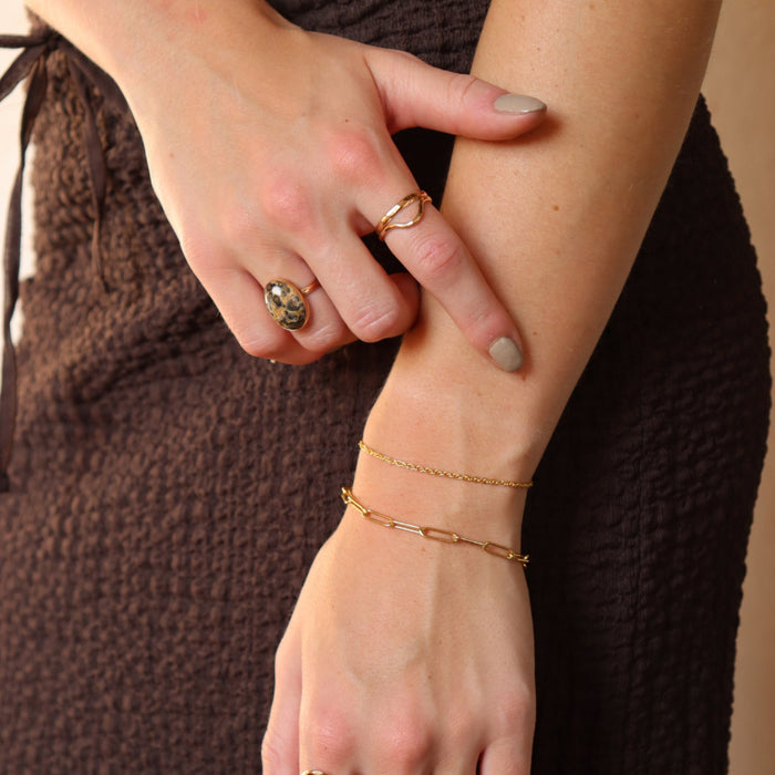 model wearing 14k gold fill jewelry focusing on a dainty 14k gold fill bracelet