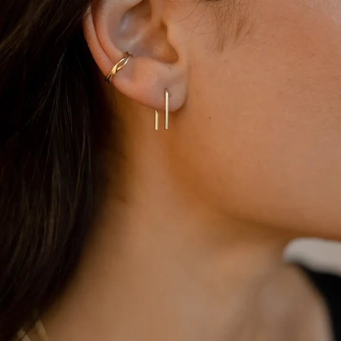 model wearing 14k gold fill staple shaped earrings with 14k gold fill ear cuff