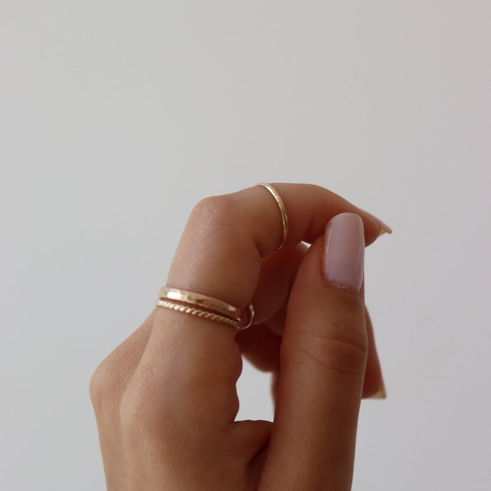 14k gold fill Minimal Midi Ring on models finger. This Ring features a simple band that is smooth perfect for everyday wear.