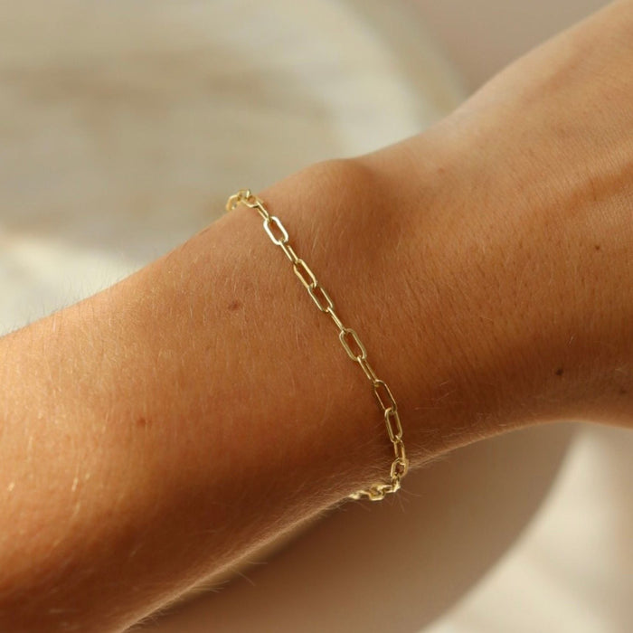 model wearing 14k gold fill paperclip chain bracelet