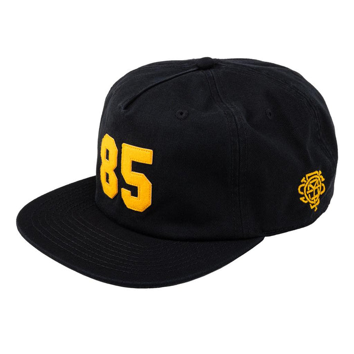Gear up for Back to School 2025 with the Odyssey 85 Cap—a stylish black 5-panel hat featuring a bold yellow "85" on the front and a small yellow embroidered emblem on the side.