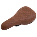 The Odyssey Aitken (Mike Aitken) Railed Seat shown here is a brown BMX bicycle seat featuring a textured, diamond-patterned surface, photographed from an angled top perspective against a white background. The design draws inspiration from Mike Aitken’s signature style.