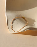 14k gold fill chain alternating with transparent opal gemstones as a bracelet in the sunlight