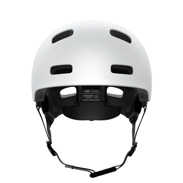 The POC Crane MIPS Helmet in Matte White, shown from the front, features multiple ventilation holes, an adjustable chin strap, and a dual-density liner for improved protection against rotational impacts.