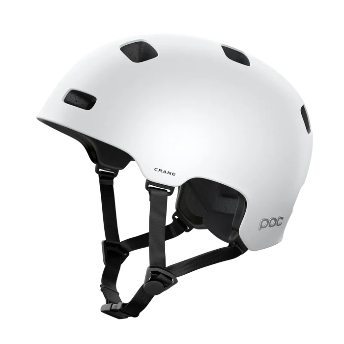 The POC Crane MIPS Helmet in Matte White features black ventilation holes, adjustable chin straps, a matte finish, and offers enhanced protection against rotational impacts.