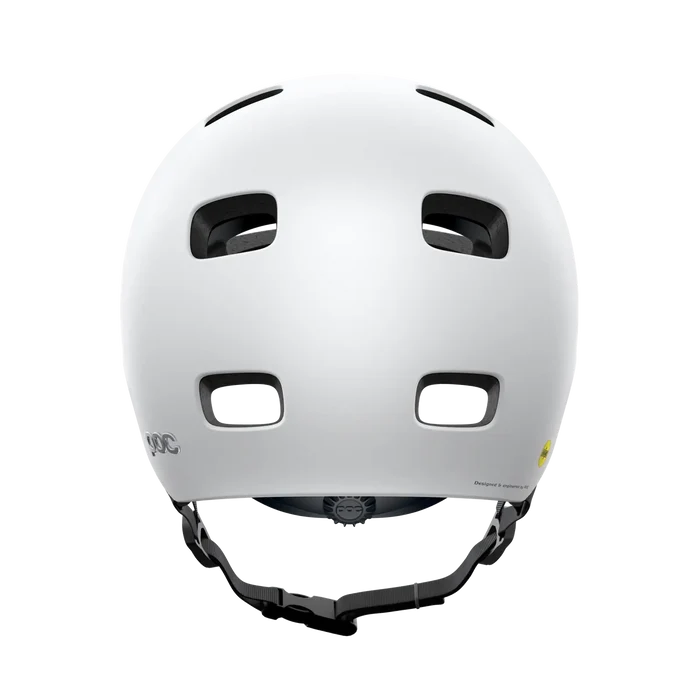 The POC Crane MIPS Helmet in Matte White is shown from the back, highlighting four rectangular vents, an adjustable chin strap, and a dual-density liner for rotational impact protection.