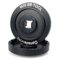 The Praxis M35 BB Tool Kit is a black tool with a central square attachment point and white labeling on the outer edge—perfect for precise crank installation.