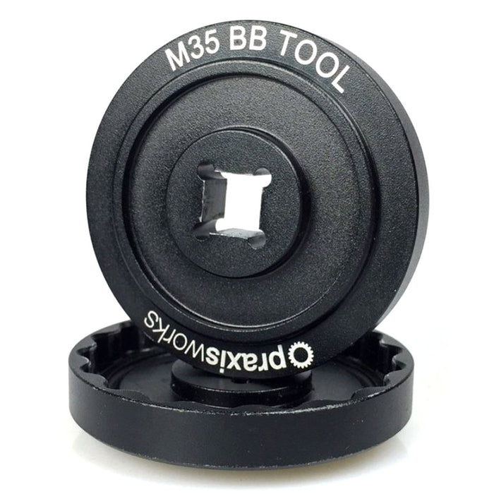 The Praxis M35 BB Tool Kit is a black tool with a central square attachment point and white labeling on the outer edge—perfect for precise crank installation.