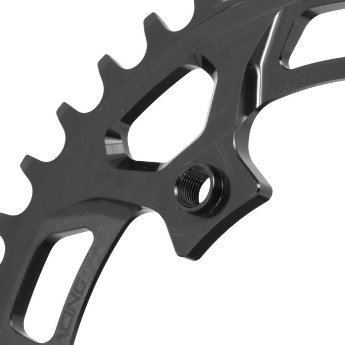 Close-up of a PRIDE Newton C1 4 Bolt Chainring / Threaded, made from black 7075-T6 aluminum, featuring a threaded hole and cut-out sections, set against a white background.