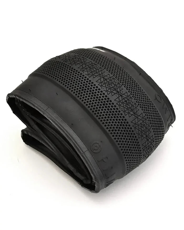 A Primo Richter 20 Inch Folding Tyre in black, sized 20x2.4 with a patterned tread and smooth sidewalls, is displayed on a white background, showcasing its lightweight folding tire design.