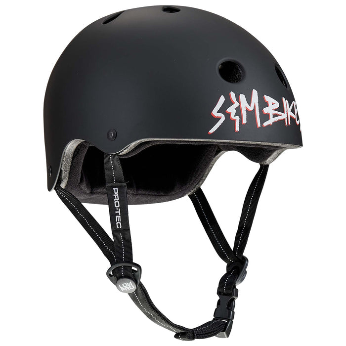 Matte black Protec S&M Low Pro Certified Helmet featuring ventilation holes, a padded interior, and an adjustable black chin strap; the "SE BIKE" logo is printed in white and red on the side. Built with high-impact ABS protection, this helmet offers both style and safety.