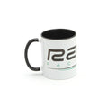 The Radio Raceline Coffee Mug is a white ceramic mug with a black handle and rim, featuring partial text and a green underline design on a plain white background.