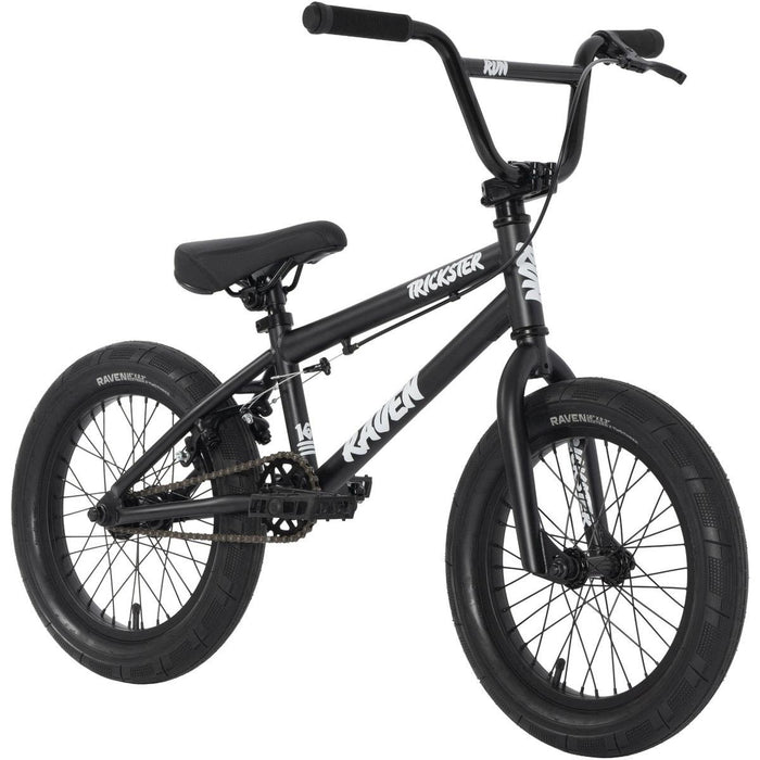 The Raven Trickster 16 Inch Bike is black with thick tires, straight handlebars, chromoly cranks, and features white "Trickster" and "Raven" branding on the frame.