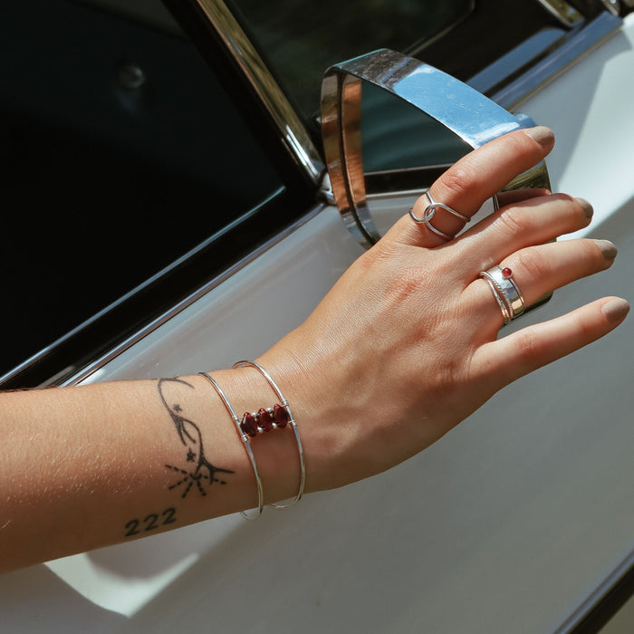 model wearing sterling silver jewelry with garnet stones
