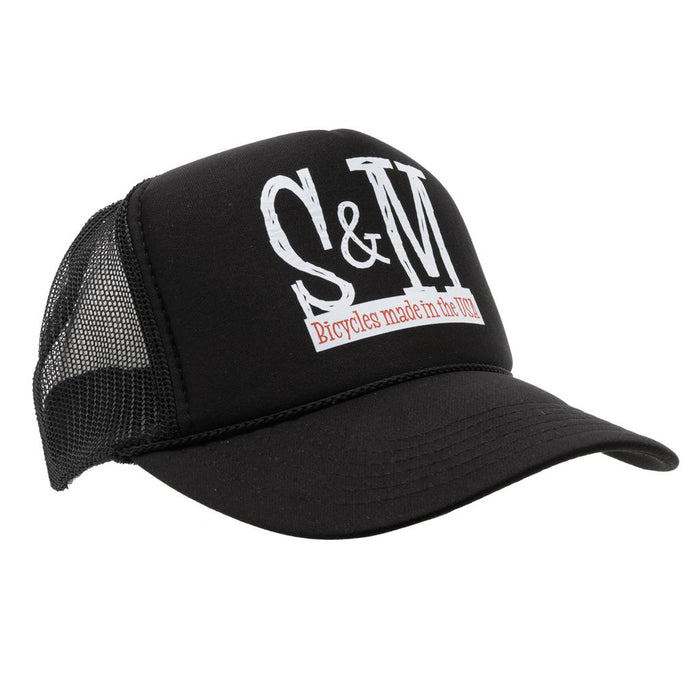 The S & M Scratch Tall Trucker Cap is a black high crown cap with a mesh back, featuring “S&M” in large white letters and “Bicycles made in the USA” in red text on the front.
