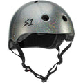 The S-One Helmet Mega Lifer in Silver Glitter features a sparkly matte silver finish, ventilation holes, black chin straps, and an "S1" logo on the front left side. This certified skate helmet provides multiple impact protection for your safety.