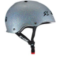 A sparkly silver S-One Helmet Mini Lifer Silver Gloss Glitter with black straps and a red buckle, featuring the "S-ONE" logo on the adjustable chin strap and the "S1" logo on the side. This multi-impact helmet is equipped with EPS Fusion Foam for superior protection.