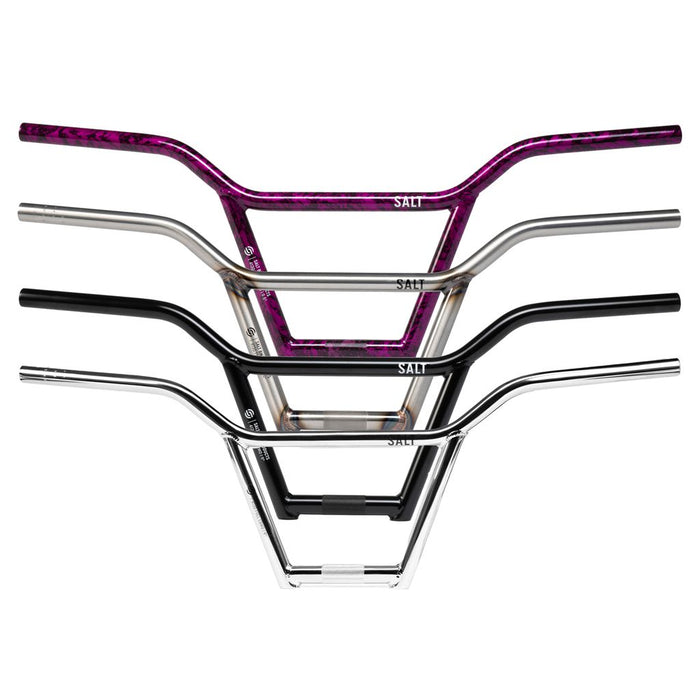 Four Salt Classic 4 Piece Bars (22.2mm Clamp) in distinct finishes—purple, matte black, gloss black, and chrome—are stacked vertically against a white background. These classic BMX handlebars combine durability and style, making them ideal for riders who demand both performance and a bold appearance.