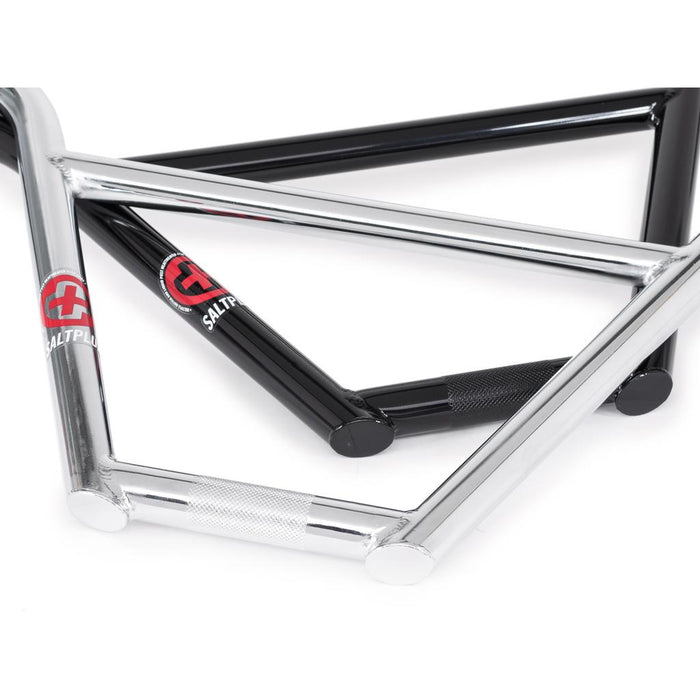 Two Salt Plus HQ 4 Piece Bars (22.2mm clamp), one black and one silver, intersect on a white background. Both chromoly handlebars display Saltplus branding and textured grip sections on the tubing, echoing the durability found in quality BMX components.