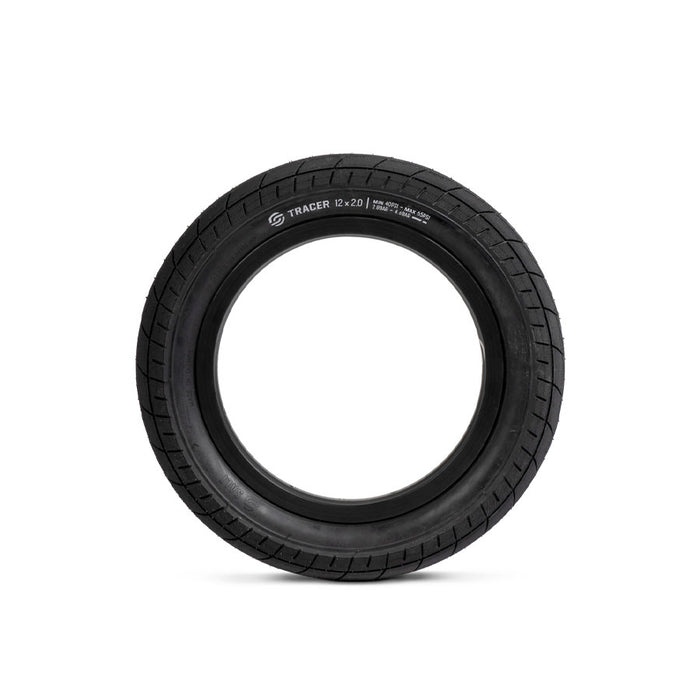 A black rubber tire standing upright, with the brand "Salt Tracer 12 Inch Tyre" and size specifications printed on its surface, offers improved traction for versatile performance.
