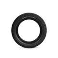 A black rubber tire standing upright, with the brand "Salt Tracer 12 Inch Tyre" and size specifications printed on its surface, offers improved traction for versatile performance.