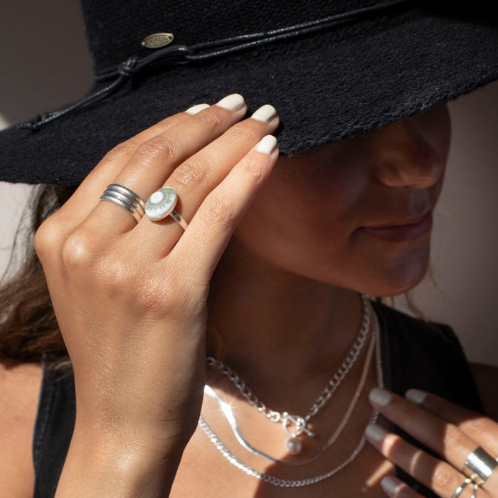model wearing sterling silver ring with oval ocean jasper stone