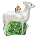 Seneca White Deer Christmas ornament with glitter standing on green tall grass.