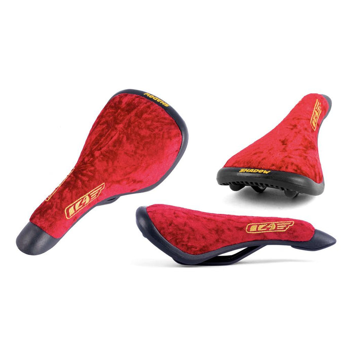 The Shadow Penumbra Railed Seat, Trey Jones S11 Signature, features three views with sleek black accents and bold yellow branding on the back and side. This red velvet bike saddle is perfect for those who value both style and performance.