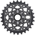 The Shadow VVS Sprocket is a black chainring made from 7075 alloy, adorned with white geometric patterns and symbols.