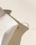 lightly hammered simple band in 14k solid gold  by a white dish in the sun
