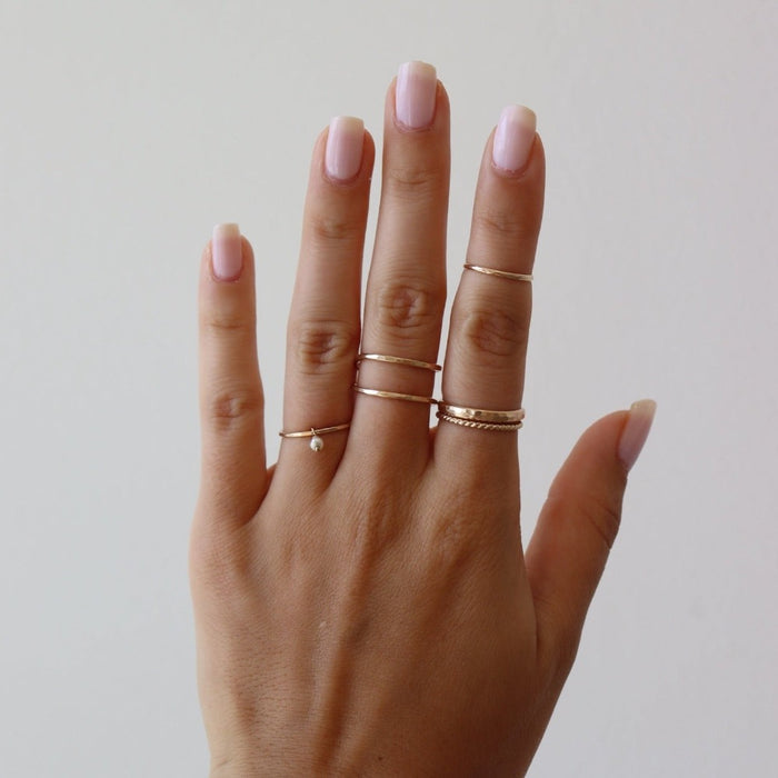 Model wearing group of 14k gold fill rings