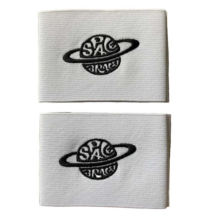 Two folded white Space Brace Ankle 2.0 Cover Straps featuring a black embroidered planet and the words “SPACE” and “BRACE,” stacked on a wooden surface—designed as replacement straps for added ankle support, comfort, and style.