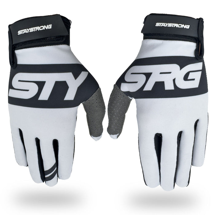 Introducing the Staystrong Glove Classic White: These cycling gloves feature a black, gray, and white design with “STAY STRONG” and “STRG” printed on the tops. Designed with Velcro wrist straps for a secure fit, these V5 gloves provide superior protection for both track training and road riding.
