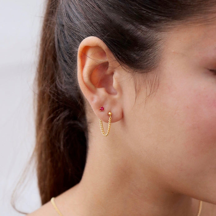 model wearing 14k gold fill small curb chain stud earrings with ruby stud earring