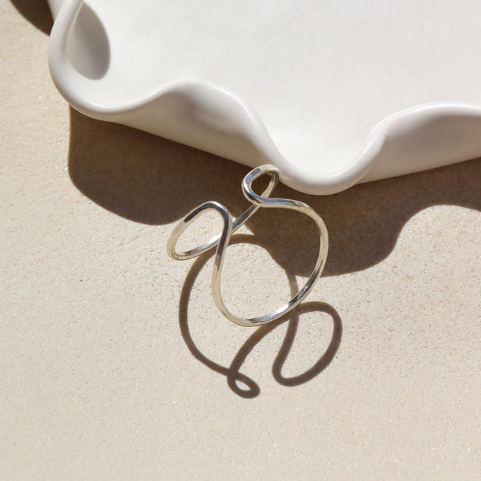 sterling silver hammered and hand shaped ring in the sunlight
