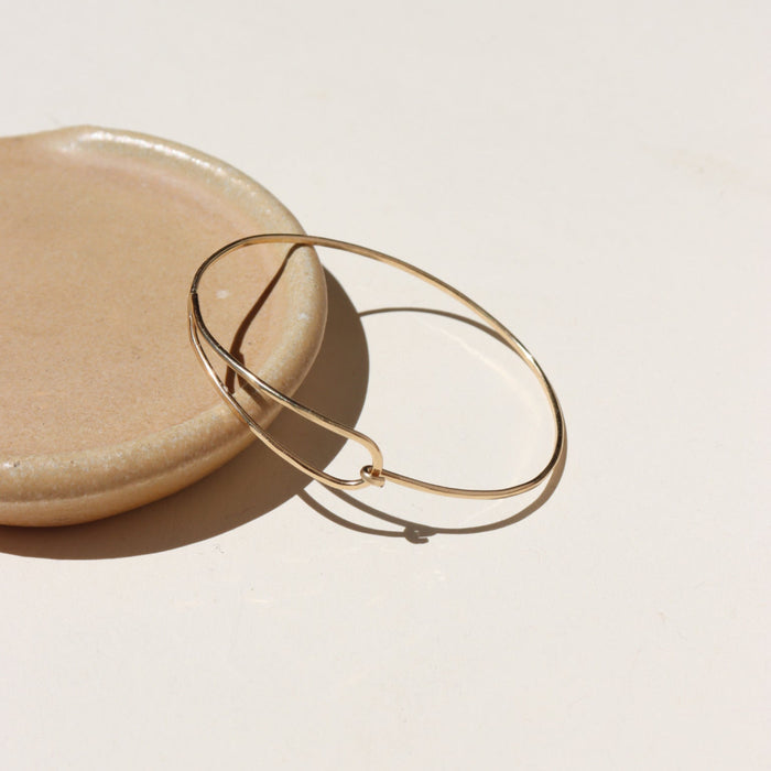 14k gold fill wire bracelet on a light dish