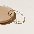 14k gold fill wire bracelet on a light dish