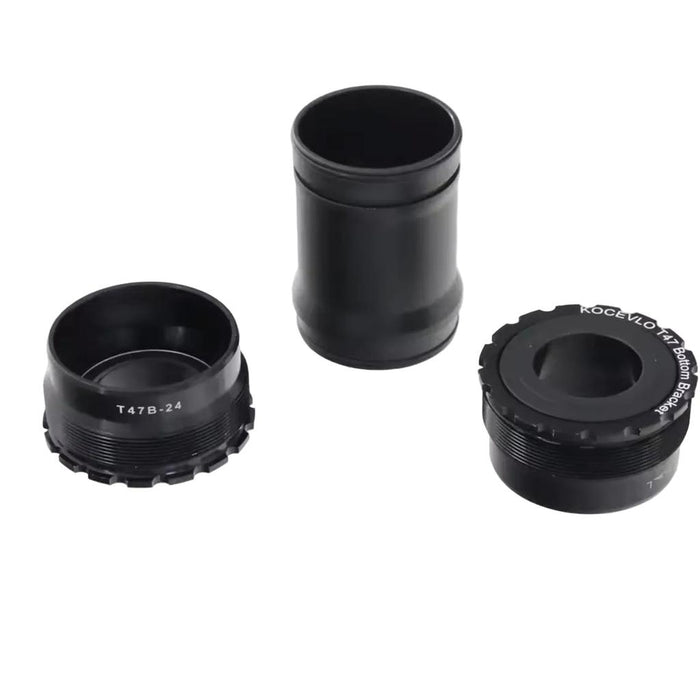 Four T47 Internal 24mm 85.5mm Bottom Bracket parts in black metal and one clear plastic ring are arranged on a white background.