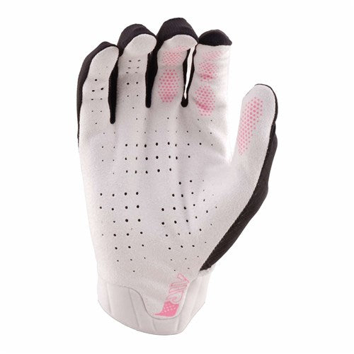 The TLD 26.1 Air Glove / Proton Black features an ergonomic fit in black and white, pink grip dots on the fingers, palm ventilation holes, and is displayed with the palm facing forward.